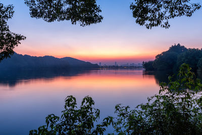 Scenic view of lake against sky during sunset