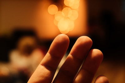 Close-up of hand holding illuminated lights