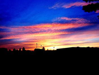 Silhouette of landscape against cloudy sky