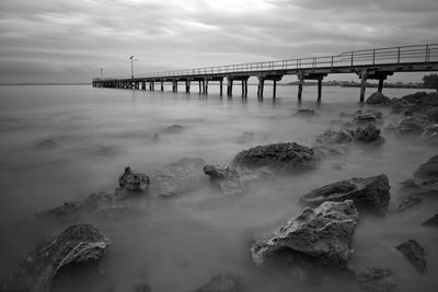 Bridge over sea against sky