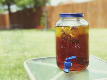 Close-up of drink in jar on table at yard