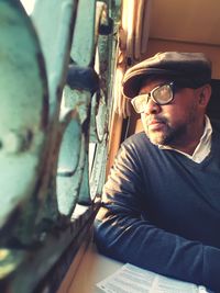 Man looking through window