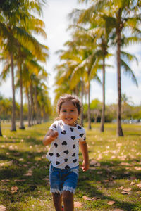 Portrait of cute boy standing on field