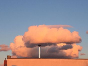 Smoke emitting from chimney against sky