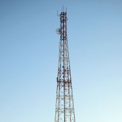 Low angle view of communications tower against sky