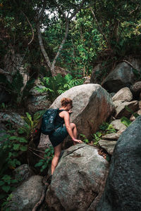 Woman on rocks in forest