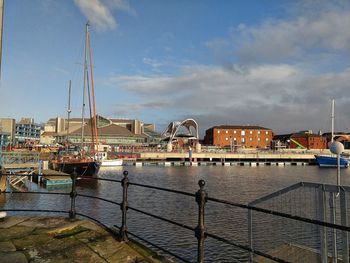 Sailboats moored in harbor