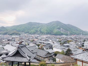 High angle view of townscape and mountains against sky