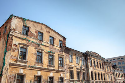 Old city building, with a damaged and dilapidated facade