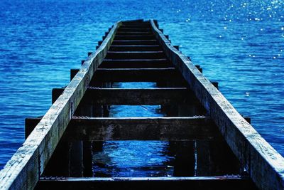 Pier over sea against blue sky