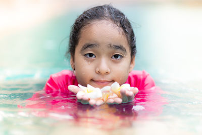 Close-up portrait of girl with flower head