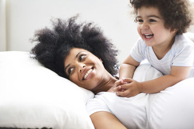 Portrait of pregnant woman and her little son at home