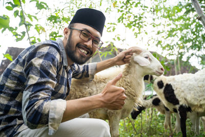 Portrait of man with goat