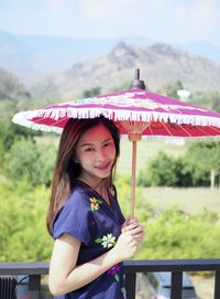 Portrait of a smiling girl standing outdoors