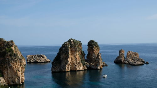 Panoramic view of rocks in sea against sky