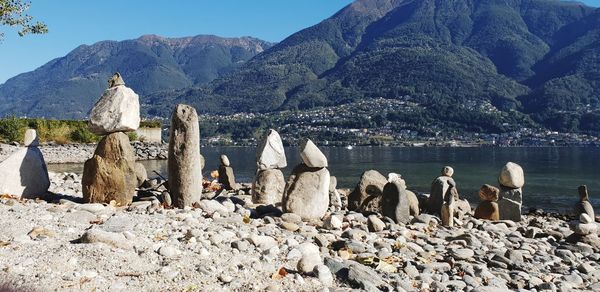 Panoramic view of rocks and lake against mountain range