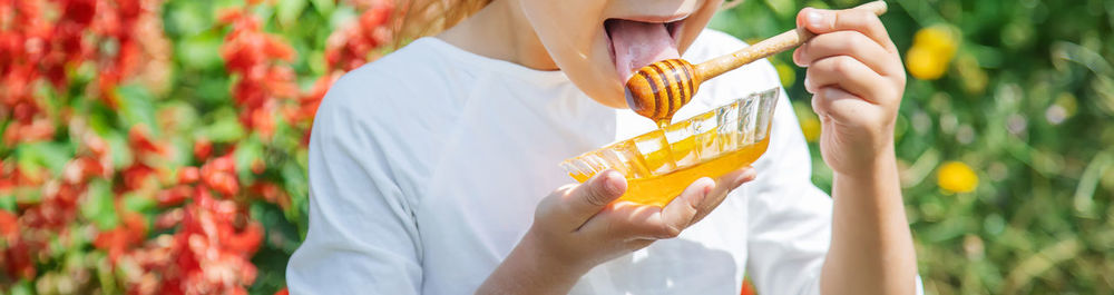 Midsection of woman holding ice cream