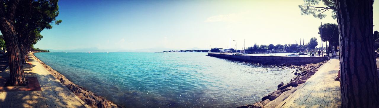 water, sea, nautical vessel, horizon over water, sky, boat, tranquil scene, transportation, tranquility, scenics, beauty in nature, mode of transport, moored, nature, beach, panoramic, shore, idyllic, blue, travel