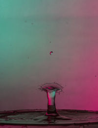 Woman paragliding over sea against sky during sunset