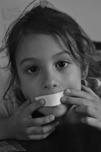 Close-up portrait of girl with tape on mouth