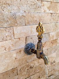 Close-up of faucet against wall