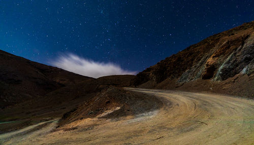 Scenic view of mountains against sky at night