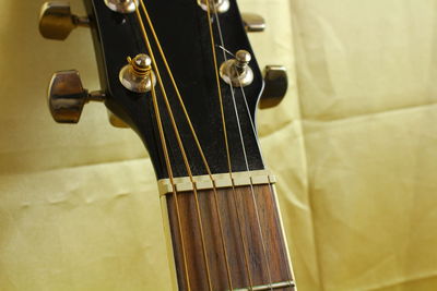 Cropped image of guitar on fabric