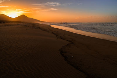 View of beach at sunset