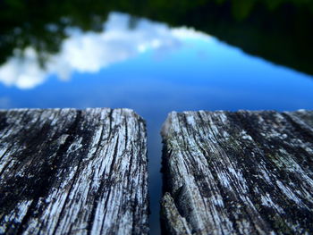 Close-up of wooden fence against blue sky