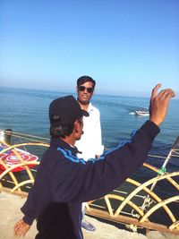 Portrait of man standing in sea against clear sky