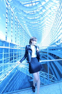 Full length of woman standing in modern building