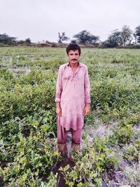 Portrait of man standing on field