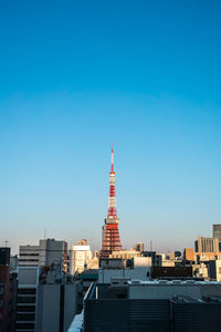 Buildings in city against blue sky