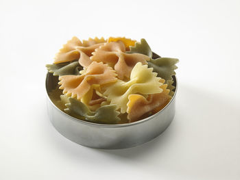 Farfalle or farfalloni dry pasta on the white background