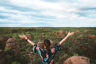 Young woman raising her hands in amazing natural scenario in brasil, unique place