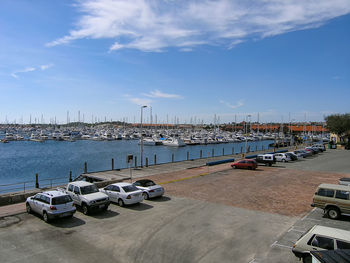 Sailboats moored at harbor