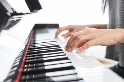 Midsection of man playing piano