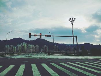 Road sign against sky in city