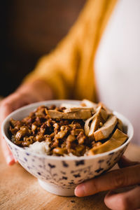 Close-up of hand holding bread in bowl