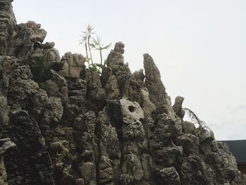 Low angle view of rock formation against sky