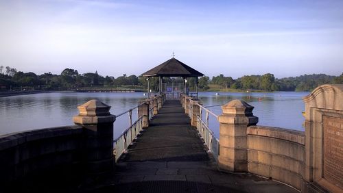 Pier over lake against sky