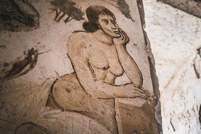 Low angle view of cross statue against wall