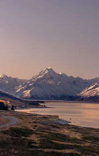 Scenic view of snowcapped mountains against sky during sunset