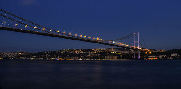 Low angle view of suspension bridge at night