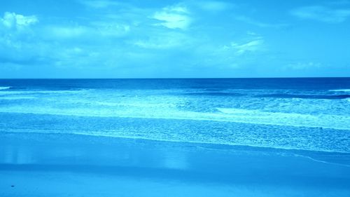 Scenic view of sea against cloudy sky