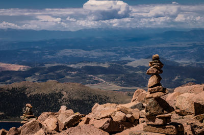 Statue on rock against sky