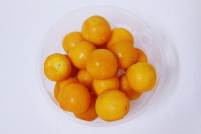 Close-up of fruits in bowl over white background