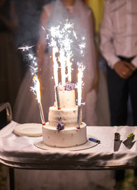 View of burning candles on birthday cake