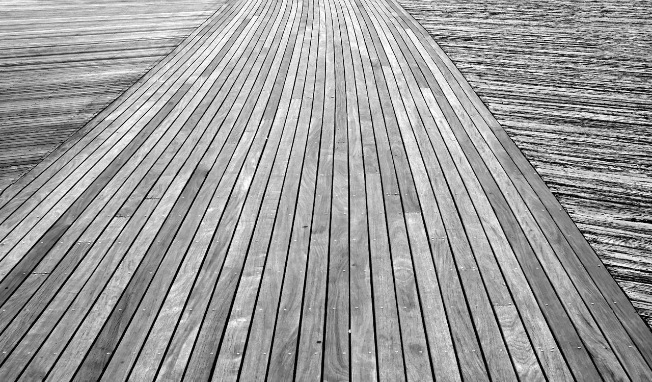 HIGH ANGLE VIEW OF BOARDWALK ON WOOD TRACK