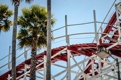 Low angle view of rollercoaster tracks against clear sky